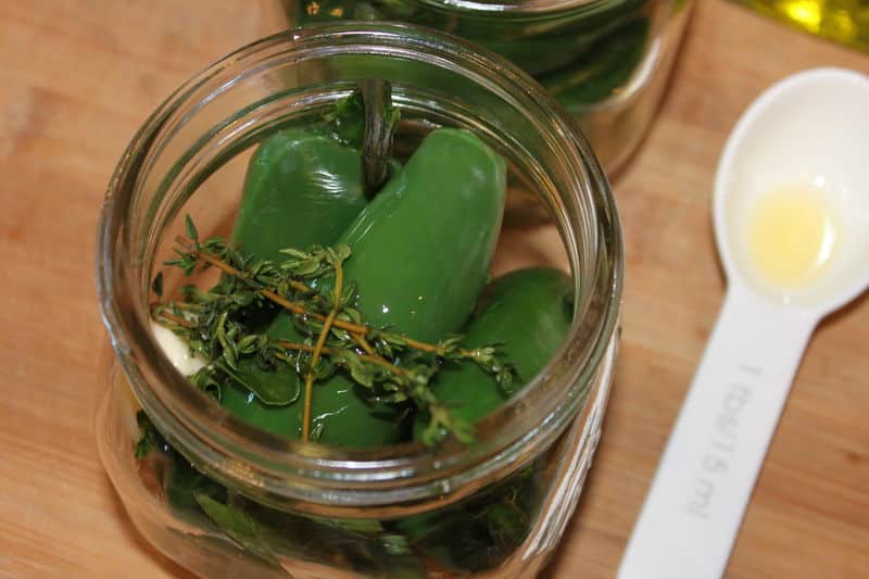 Pack hot blanched whole peppers tightly into sterilized jars along ...
