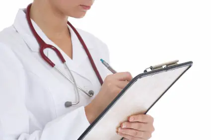 Woman Doctor is Writing a Card of a Patient