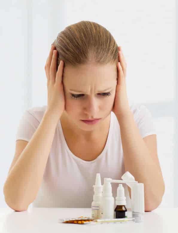 woman with a headache and flu and with medicines