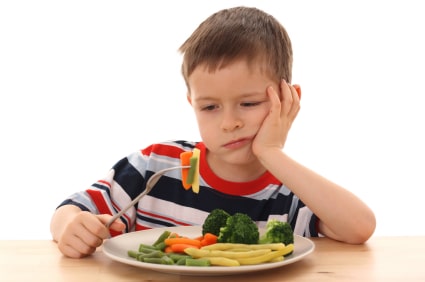 boy eating veggies